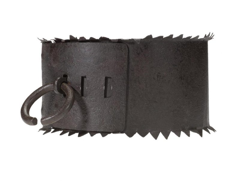 A dark brown iron collar with a ring attached and jagged edges