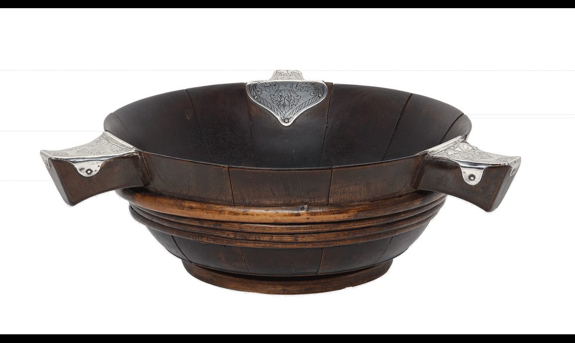 A shallow wooden bowl with three short handles that have small plates of silver on top.