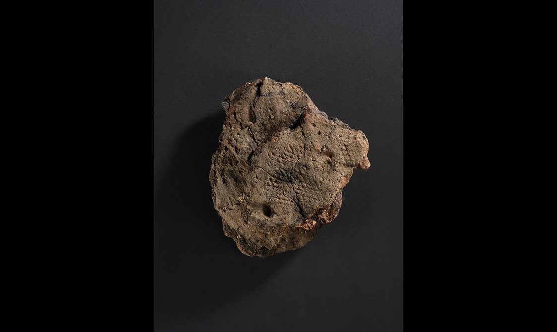 A lump of clay with a criss cross pattern impressed onto it