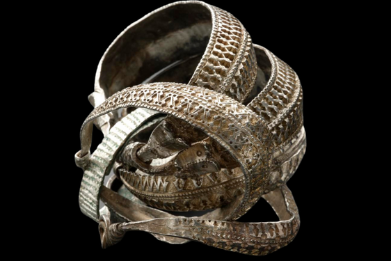 A group of five tarnished silver bangles with elaborately decorated surfaces