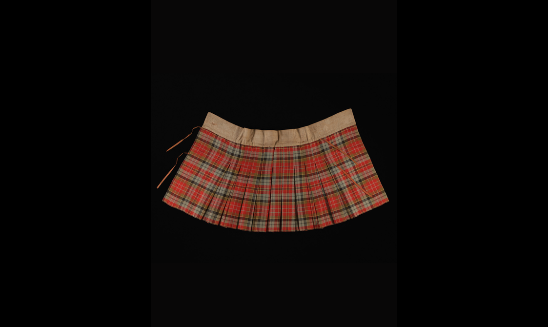 The inside of a red tartan kilt with a brown waist band.