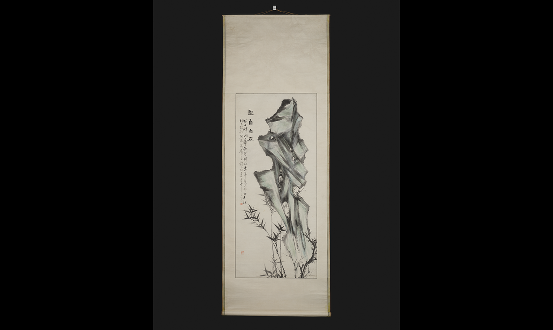 A long rectangular hanging scroll depicting a rock, bamboo and plum blossom