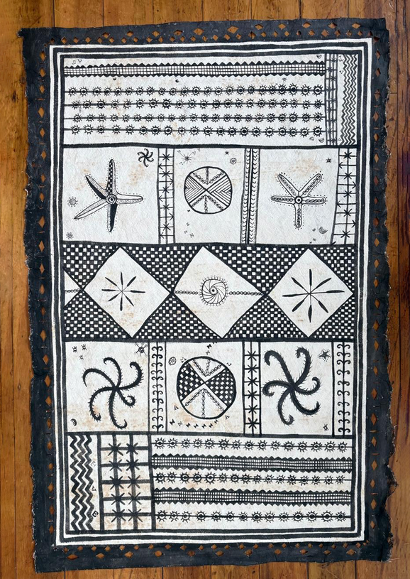 A black and white rectangular piece of barkcloth with nature illustrations