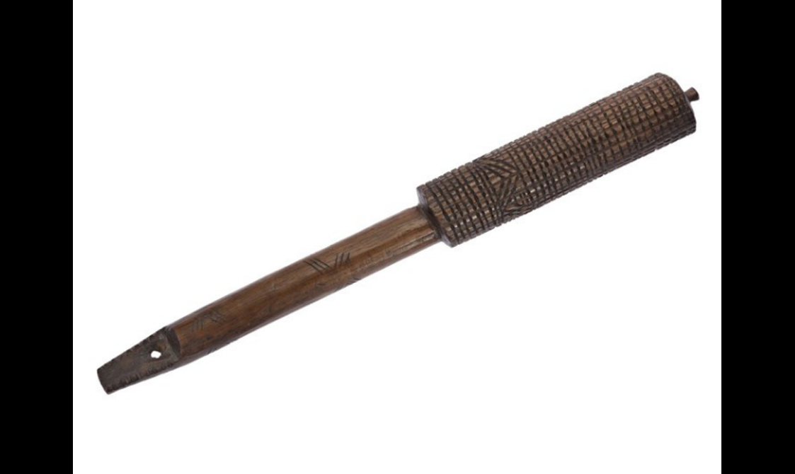 A long wooden rod with an intricately carved handle.